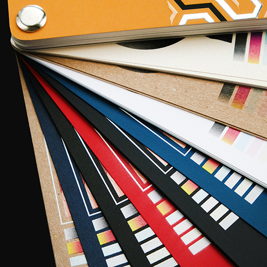 Colorful printed products and branded merchandise arranged in a creative studio